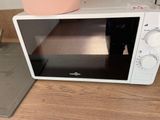 a microwave that is sitting on a table with a pot
