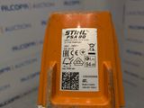 a close up of an orange plastic object with a sticker on it