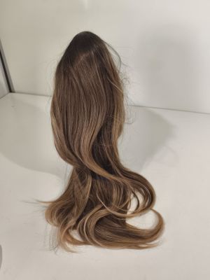 a close up of a wig on a table with a mirror in the background