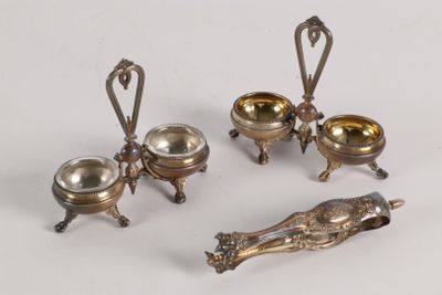 three silver plated dishes and spoons on a white surface