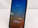 a close up of a phone on a stand on a white surface
