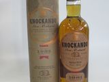 an image of a bottle of knockand whisky next to a cardboard box
