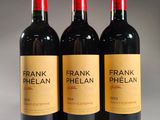 three bottles of frank phelan red wine sit on a table