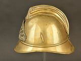 gold helmet on a stand on a gray background