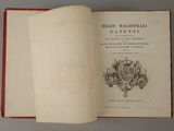 an open book with a picture of a coat of arms and a crown on it