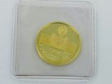 a gold coin with a picture of a train on it