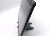 a tablet computer sitting on a stand on a white surface