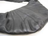 a close up of a black leather purse on a table