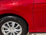 a red car parked on the side of the street