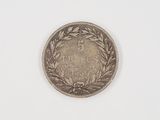 a close up of a coin on a white surface with a white background