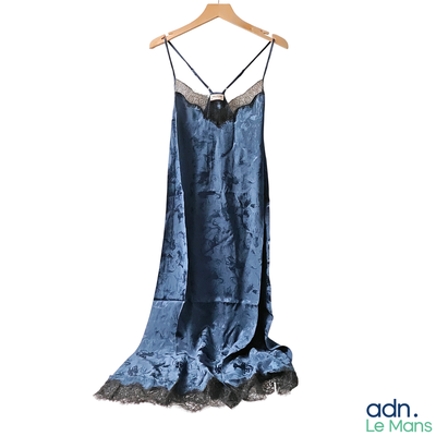 a blue dress hanging on a hanger on a white wall