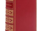 un livre rouge avec des bordures dorées et une couverture aux bordures dorées