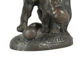 a statue of a dog with a ball in it ' s mouth