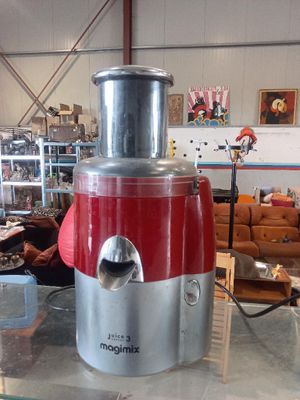 a red and silver blender sitting on top of a table