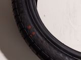 a close up of a tire tire on a white surface