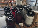 many kegs of different sizes and colors on a pallet