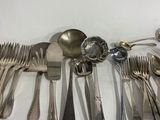 a lot of spoons and forks on the table