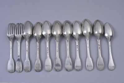 six spoons and a fork are lined up on a table