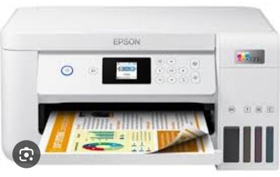 a white printer with a magazine in front of it on a white background