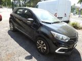 a black car that is parked on the side of the road