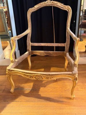a wooden chair that is sitting on a hard wood floor