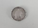 a close up of a coin on a table with a white background