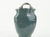a green vase with a handle on a white background