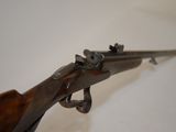 a close up of a rifle mounted on a wall