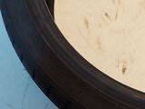 someone is holding a tire tire with a small hole in it