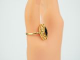 a gold ring with a black stone on it