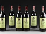 six bottles of red wine are lined up in a row