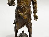 bronze statue of a man with a dog on a marble base