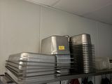 many pans and pans on a shelf in the kitchen