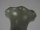 a green vase that is sitting on a table