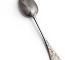 a spoon that is sitting on a white surface