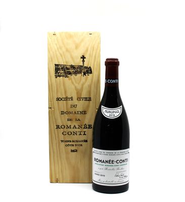 a bottle of wine sitting next to a wooden box