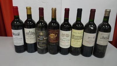 several bottles of wine are lined up on a table