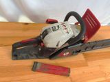 the chainsaw is sitting on the table next to a piece of wood