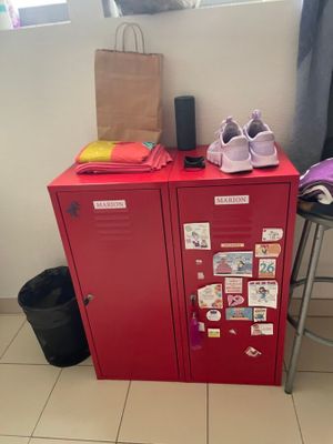 a red locker with a bunch of items on top of it