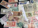 many different types of paper money on the table