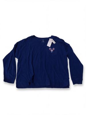 a women ' s long - sleeved shirt with a white tag on the chest