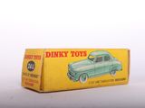 a box of dinky toys sitting on a white surface