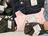 a lot of clothes and shoes that are on a table