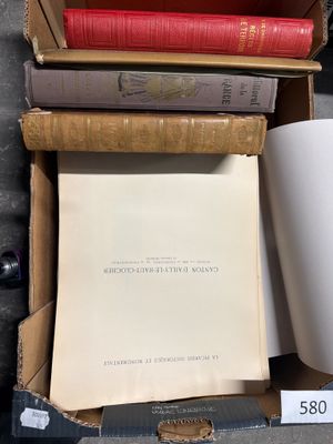 a box of books and a cup of coffee on a table