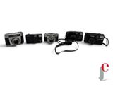 five cameras sitting next to each other on a white surface