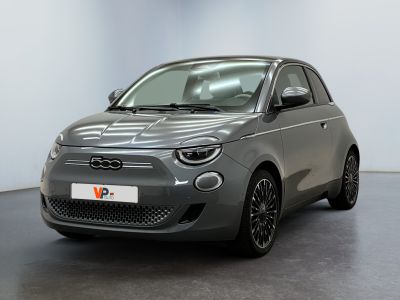 the grey car is parked in a large room with a black floor