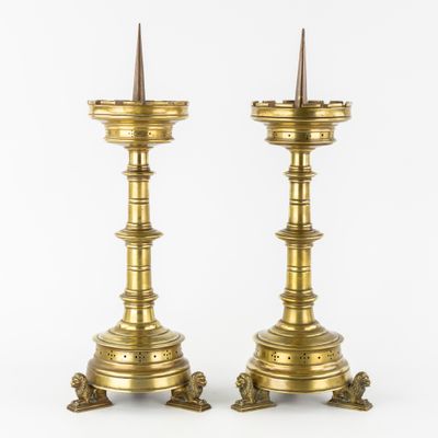 a pair of brass candlesticks with spikes on each of them