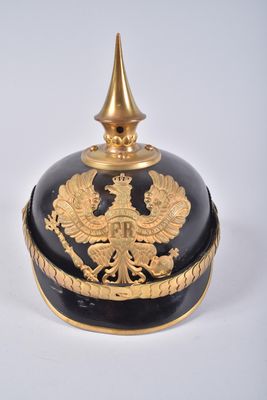 a black and gold vase with a gold bird on it