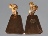 pair of gold tone earrings with a square design on each side