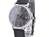 a close up of a wrist watch with a black leather strap